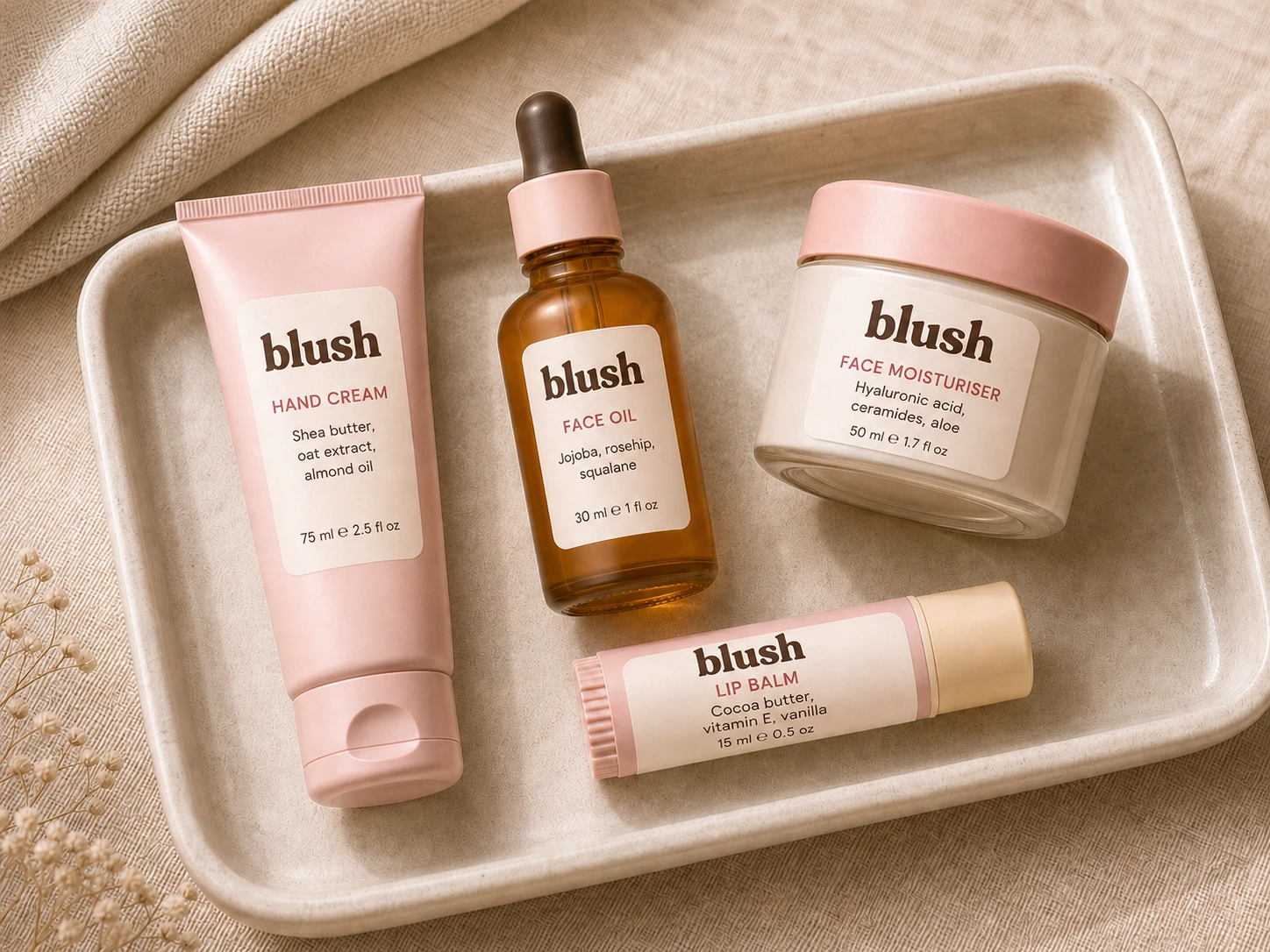 Hand cream, face oil, face moisturiser, and lip balm arranged in a cream tray
